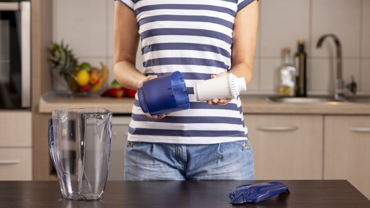 Woman replacing filter in a water pitcher