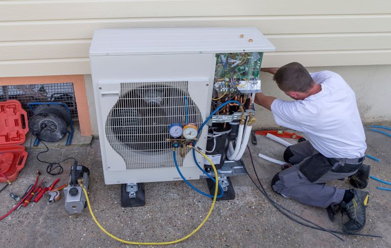 Man installing heat pump system