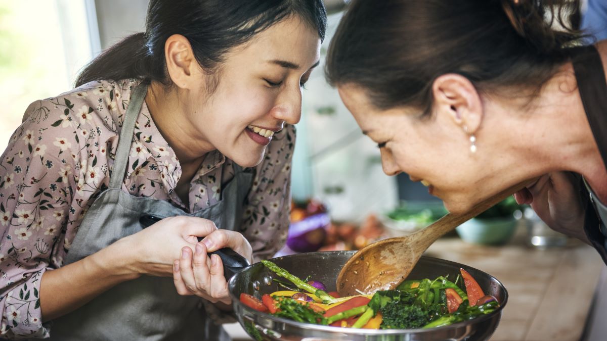 Women cooking vegetable dish