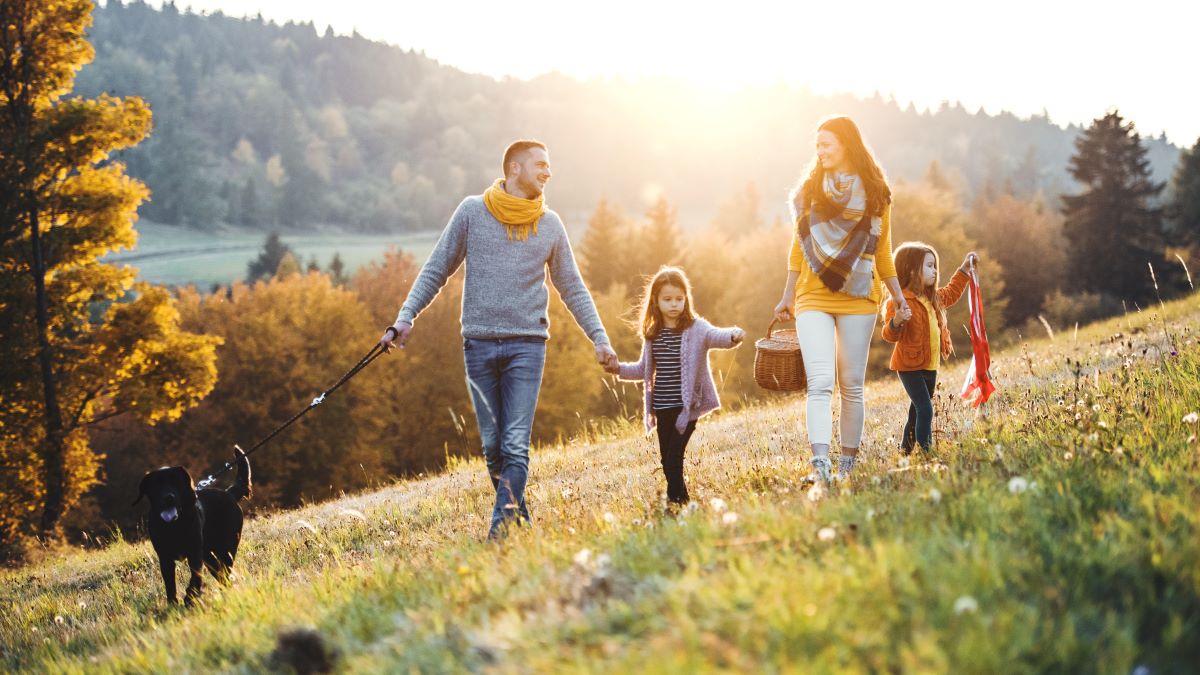 Young family walking in meadow