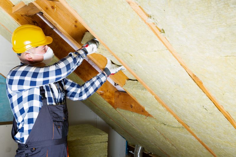 Man installing attic insulation