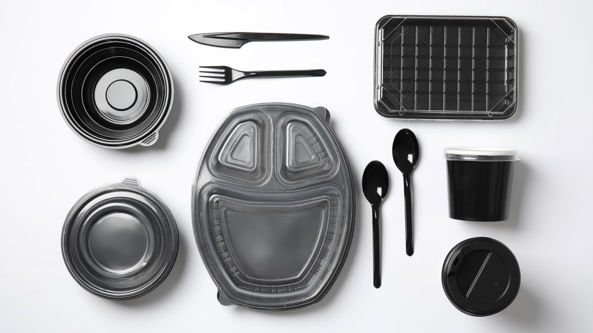 food packaging and utensils in black-colored plastic