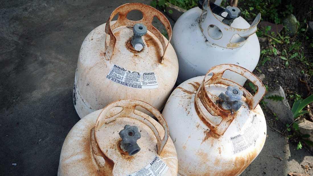 Old rusty propane tanks on patio