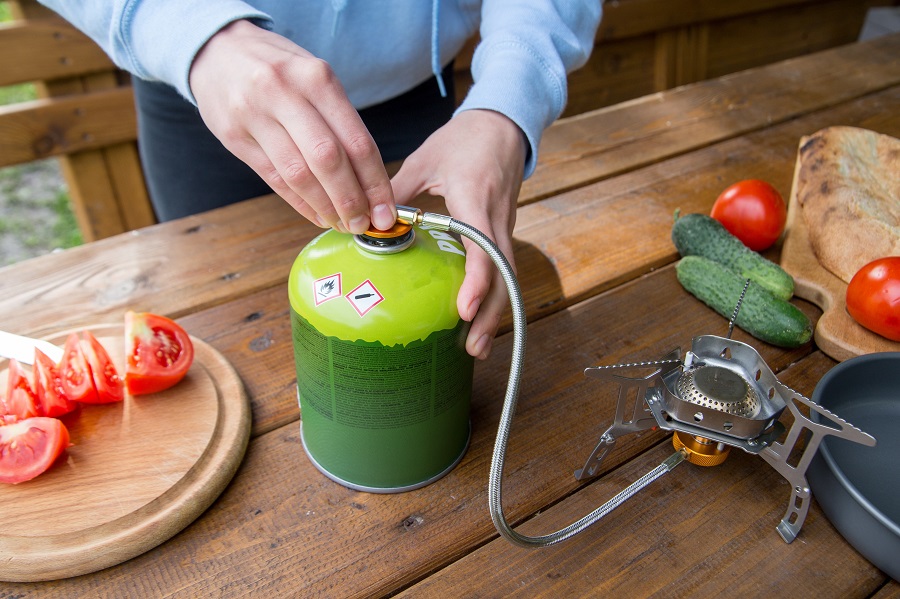 Gas canister attached to camp stove