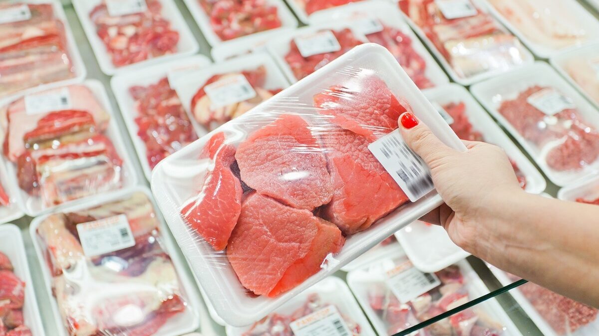 woman's hand holding packaged meat