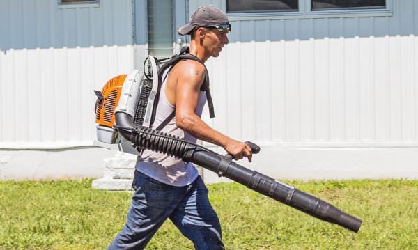Man carrying leaf blower