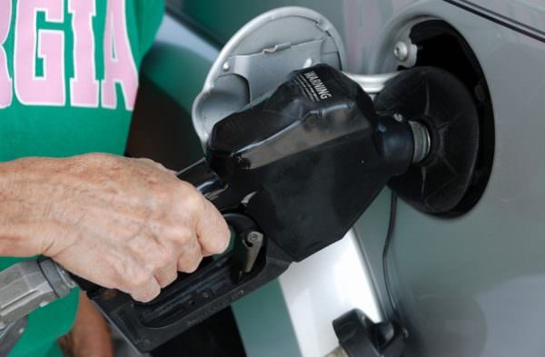 man pumping gas into vehicle